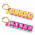 Personalised name keyrings with colourful letter blocks, flower charms and gold-tone ball chains