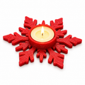 Red snowflake-shaped candle holder with a tealight shown in the centre
