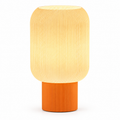 Modern table lamp with a rounded white ribbed shade and cylindrical orange base
