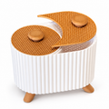 White ribbed two-compartment organiser with decorative gold-toned lids on a white background
