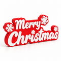 Red Merry Christmas sign with raised white script lettering and white snowflakes