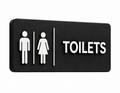 Black 3D printed Toilets door sign with white raised icons and lettering