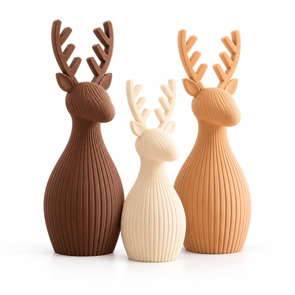 Three ribbed Christmas reindeer decorations in brown, white and salmon on a white background