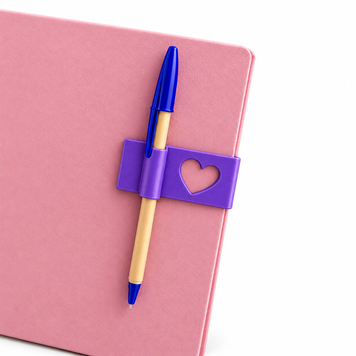 Heart-detail bookmark and pen holder displayed on a pink notebook