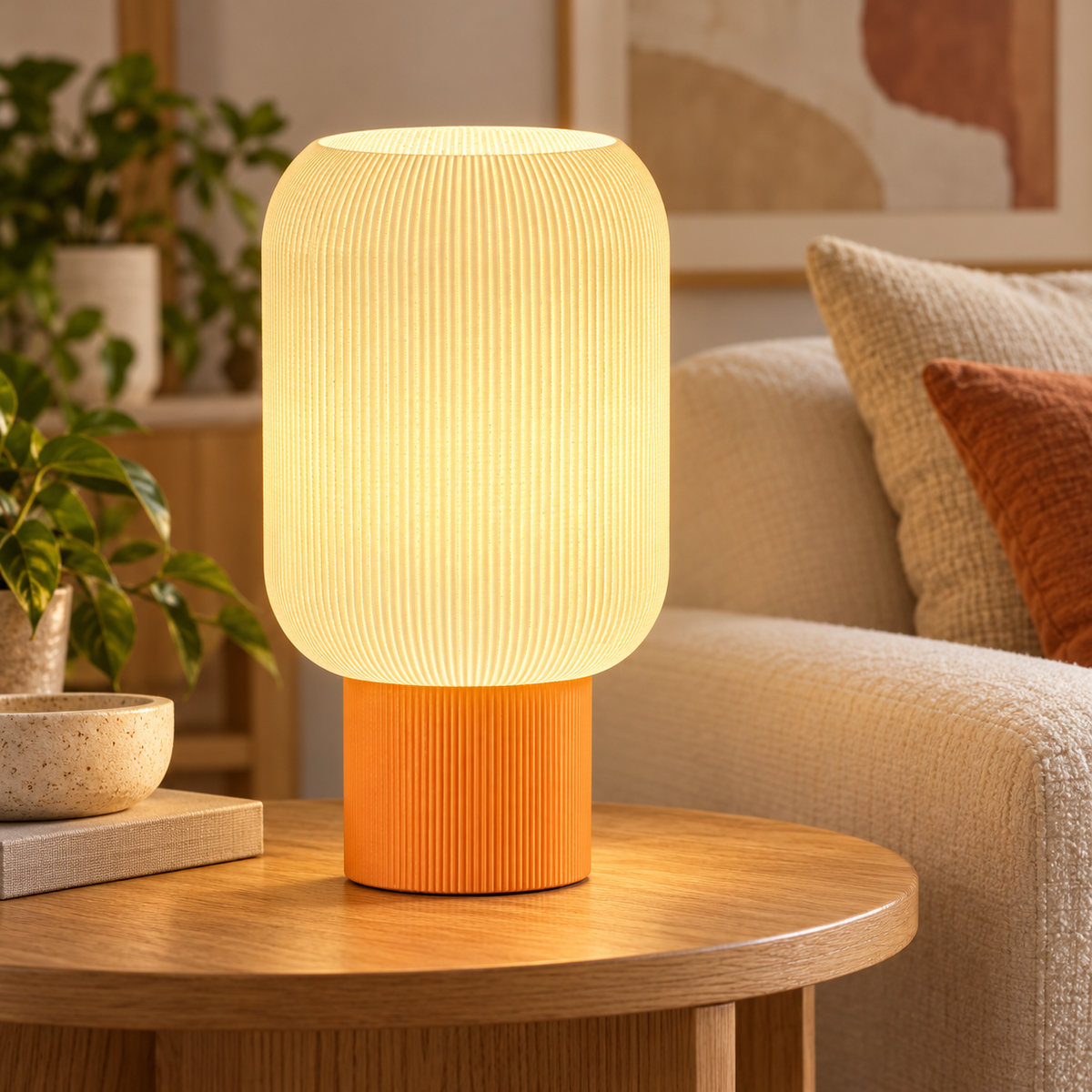 White and orange ribbed table lamp displayed on a wooden side table beside a sofa